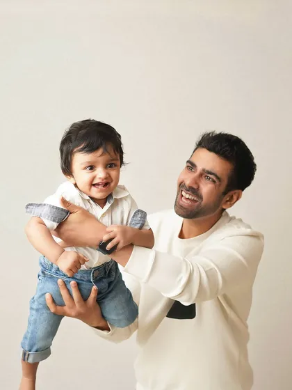 A father's joy is evident as he lifts his laughing son. I love capturing these energetic and playful interactions that show the fun side of fatherhood.