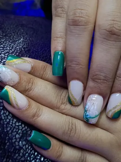 An elegant green and gold set with delicate white floral painting.