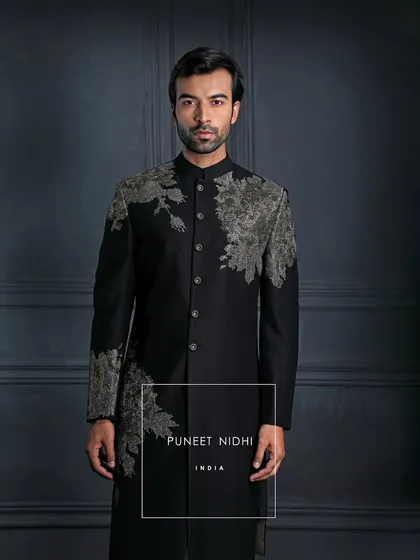 Draped in black, detailed in art. This achkan is more than attire; it’s the silence that speaks, the strength that doesn’t need to be loud.