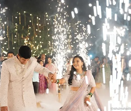 The couple's grand entrance, hand-in-hand, through a path of sparklers.
