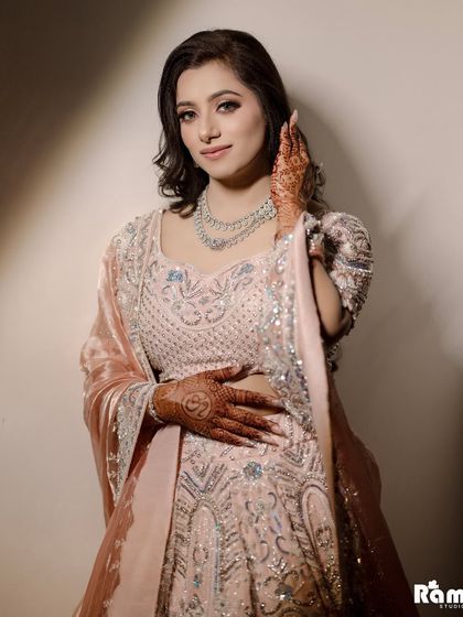 A beautiful close-up portrait of the bride on her engagement day, highlighting her flawless makeup and the delicate embroidery on her outfit.