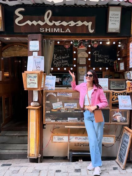 A casual and cool outfit for a birthday getaway to the mountains. I paired a pink denim jacket with a simple white top and light-wash jeans, a perfect look for exploring a charming town like Shimla.