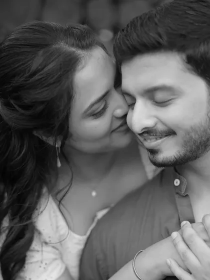 A classic black and white portrait that emphasizes emotion. This close-up from a pre-wedding shoot captures a quiet, affectionate moment between the couple, proving that sometimes the simplest shots are the most powerful.