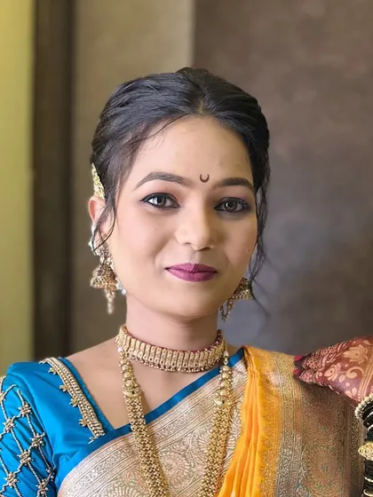 A simple and elegant portrait of the bride, with a focus on her expressive eyes and the traditional 'chandrakor' bindi.