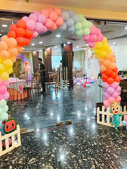 A Cocomelon themed entrance arch for a second birthday party. This welcoming pastel balloon arch features Cocomelon character cutouts and a personalized welcome sign for the birthday boy.