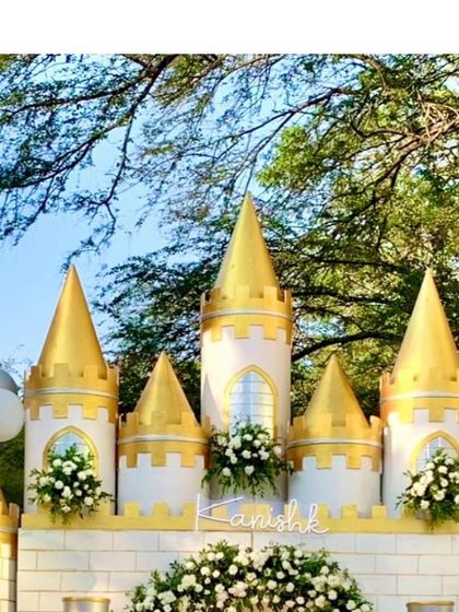 A close-up of the castle turrets, showcasing the gold-painted details and floral accents that bring the structure to life.