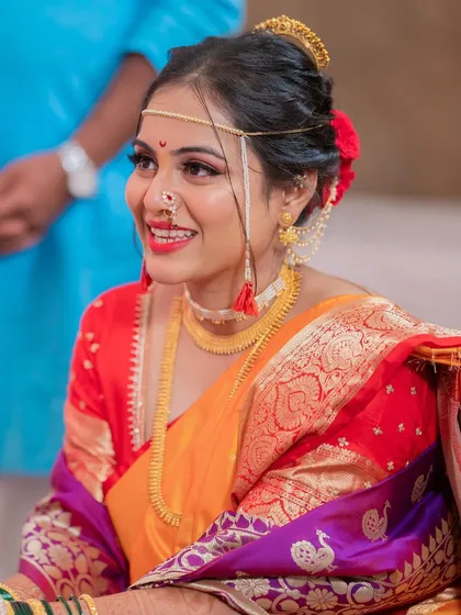 A close up of the classic 'vidhi look'. The bright red lip, traditional bindi, and Maharashtrian nath all come together with glowing skin to create a look that is both traditional and timeless.