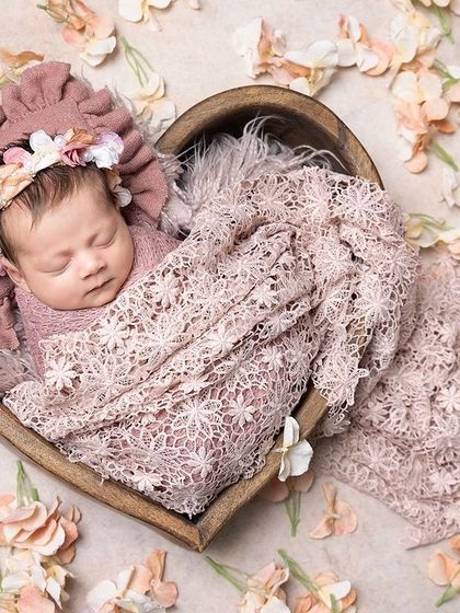 A little flower bud ready to bloom. This heart-shaped bowl, surrounded by petals, is a beautiful way to symbolize the love that surrounds your new baby.