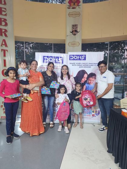 A happy group of families and children receiving prizes at the end of our Doms workshop. Celebrating their effort and creativity is an important part of the experience.