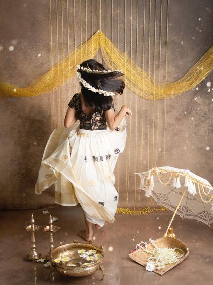 A candid moment of a girl twirling in her Onam skirt. I love to capture these moments of spontaneous joy during our festive sessions.