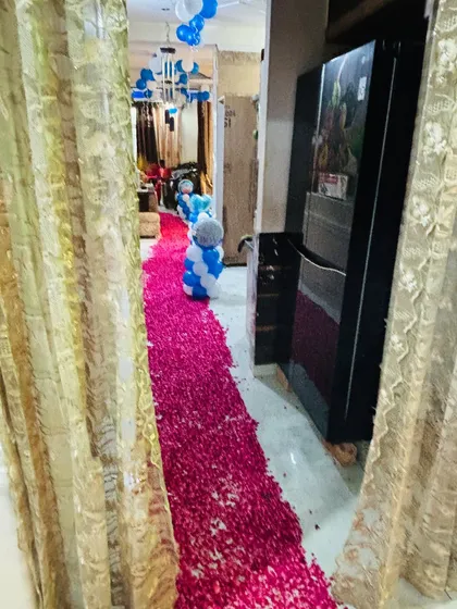 A long pathway of rose petals leading into the house to welcome the new baby.