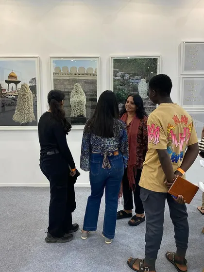 A wider view of Surekha in conversation with guests about her art.