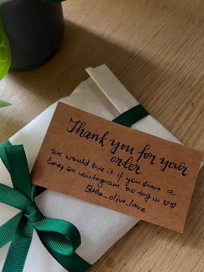 A handwritten thank you note going out with a sale order. Your support means the world, especially during this transition.