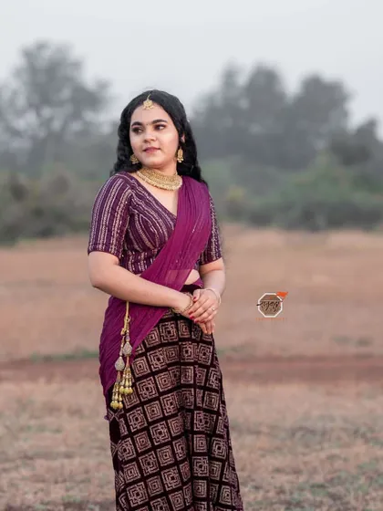 A full-length standing shot from my portfolio photoshoot, showcasing the flow of the saree and the overall styling.