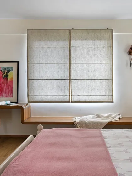 A view of the second daughter's bedroom in 'House of Kismish', showing the custom floating study desk that continues into a window seat.