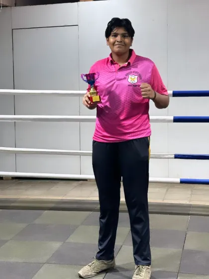 One of my fighters holding her trophy after a win at the "PINK POWER" open invitational tournament. Every win, big or small, is a step forward.