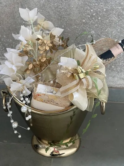Our Champagne Bucket, transformed into an exquisite gift hamper with delicate florals and pearl accents. It is the perfect statement gift for weddings, anniversaries, or any grand celebration.