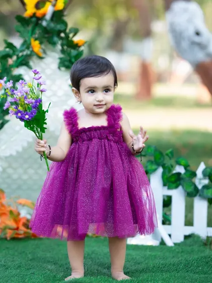 This birthday girl looks lovely in her sparkly purple dress.