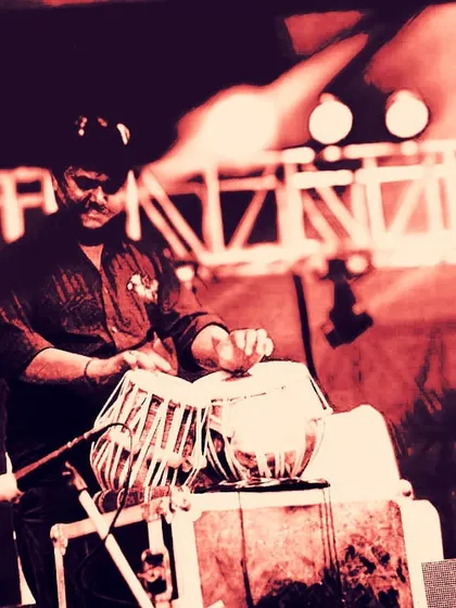 An artistic, red-tinted photo of me playing on a professionally lit stage. This image captures the high energy and modern aesthetic of a large scale fusion music concert.