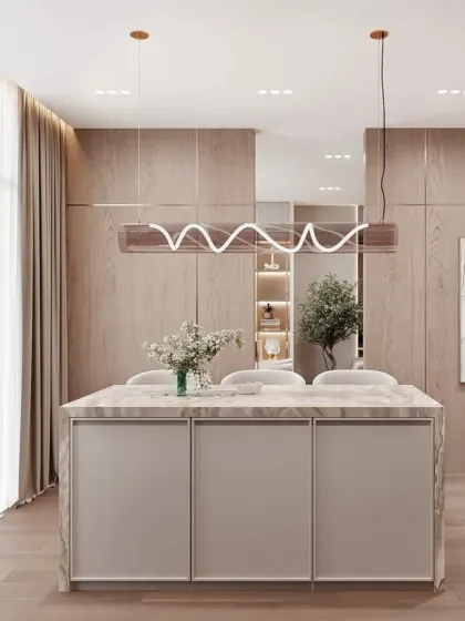 The other side of the marble island, showing how it provides both a workspace and storage. The design is perfect for open-concept homes.