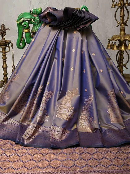 This is the epitome of luxury. A pure Kanjivaram silk saree in a deep, lustrous purple, featuring intricate tree-of-life motifs woven in gold zari. This is a heritage piece, perfect for a bride or for any grand celebration where you want to embody grace and tradition.