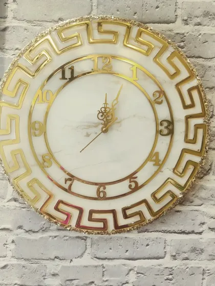 This gorgeous 18 inch marble effect golden clock is available for sale. It's a handmade statement piece that will elevate any room.