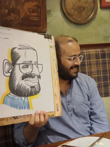 A guest looking thoughtfully at his caricature.