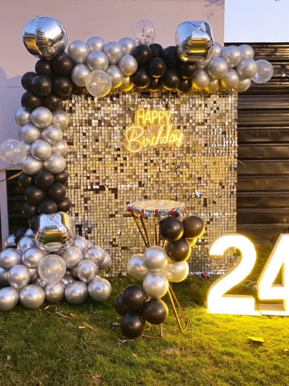 A full view of the stylish silver and black balloon decor for a 24th birthday.
