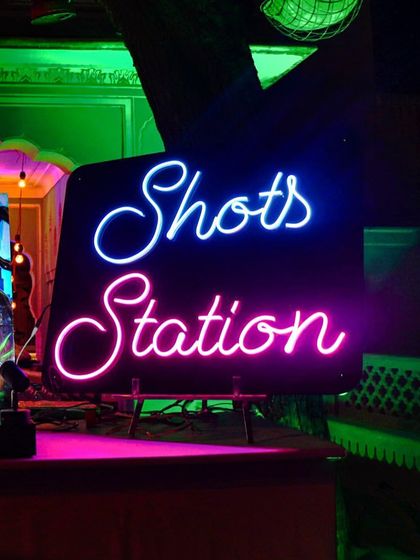 A dedicated 'Shots Station' with a bright neon sign. This is the go-to spot for guests looking to kick the party up a notch.