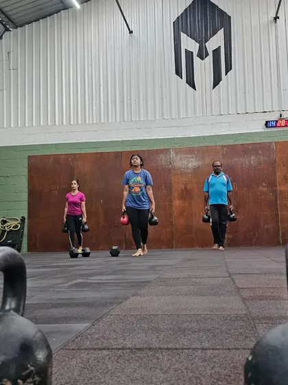 Here's a hard truth: a good functional training program should include carries. Here, our members perform a kettlebell farmer's carry, an exercise that builds grip strength, core stability, and overall resilience.