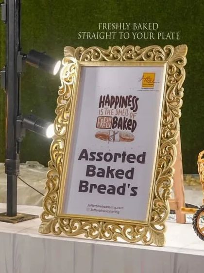 Happiness is the smell of freshly baked bread. Our assorted baked breads station, with its charming decor and signage, offers a variety of artisanal breads straight from the oven to your plate.