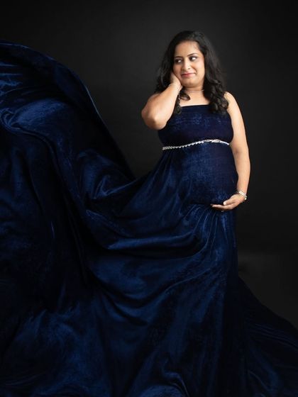 The beauty of a flowing gown. The deep blue velvet fabric creates a dramatic wave, adding movement and elegance to this self-portrait from my maternity session.