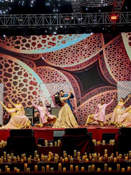 A full-stage view of a Sufi-themed couple performance. The combination of the candle-lit stage, intricate LED patterns, and graceful choreography created a truly mesmerizing and soulful experience.