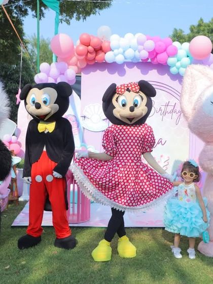 The birthday girl posing with all the character mascots. These photos are always a favorite for the kids.