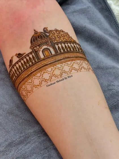The arm band design is further developed with shading and a geometric pattern below the palace scene.
