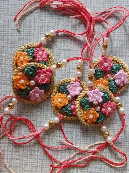 A set of beautiful floral rakhis with pearl details, perfect for celebrating special bonds.