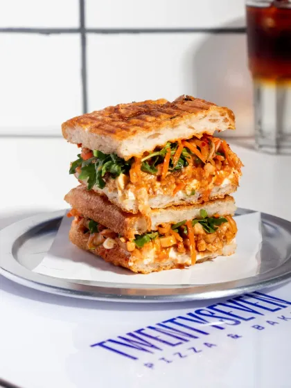 A stacked view of the Pulled Pork Kimchi Focaccia, showcasing its generous filling and perfectly grilled bread.