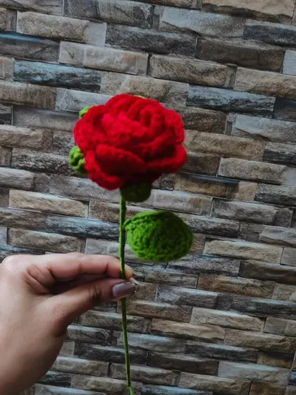 A simple, elegant shot of my single red crochet rose against a stone wall. The quality of the handmade flower speaks for itself.