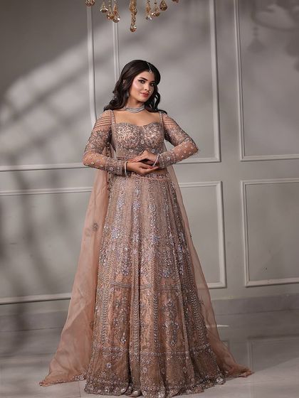 Another pose from the engagement shoot, showing the intricate details of her outfit and the flawless makeup that completes the look.