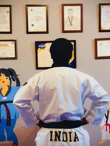 I often stand here and look at the achievements on the wall. The word 'INDIA' on my back is a constant reminder of my mission. I am not just a coach, I am here to create future champions for our country.