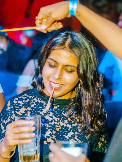 A fun, candid moment at the bar. The party extends beyond the dance floor.