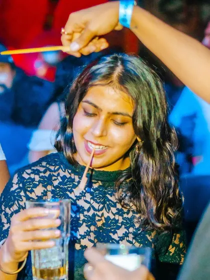 A fun, candid moment at the bar. The party extends beyond the dance floor.