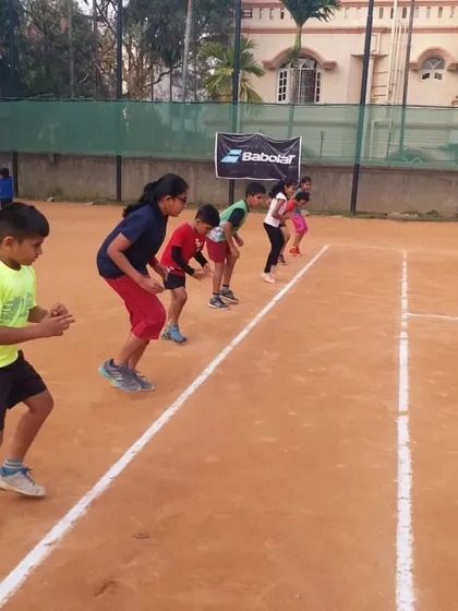 Energy and enthusiasm are key in our junior batches. This is the starting line for an agility drill, where kids learn to be explosive and quick on their feet, a crucial skill for any aspiring tennis player.