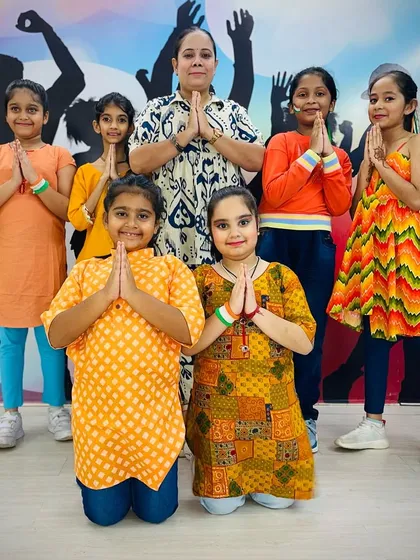 The full group of performers for our Independence Day event, posing with their instructor in a gesture of respect and unity.