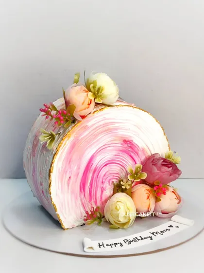 Another view of the pink top-forward cake, showing its unique shape and the beautiful texture of the buttercream.