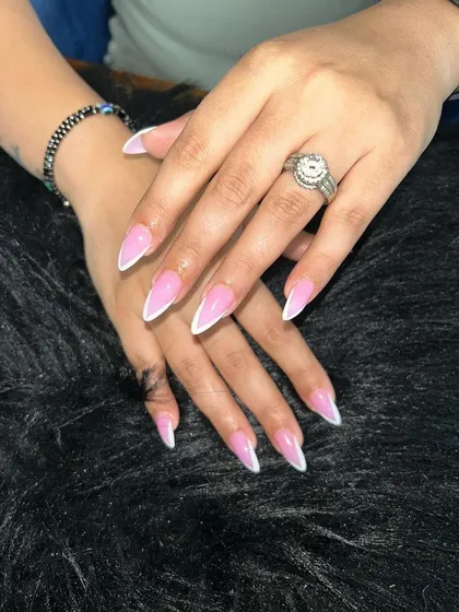 A sharp, stiletto-shaped French manicure. The dramatic length and classic white tip create a bold yet elegant statement.