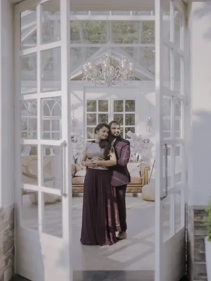 Framed by the doors to their future. This shot uses the architecture of a beautiful glasshouse to create a sense of beginning, with the couple standing together on the threshold.