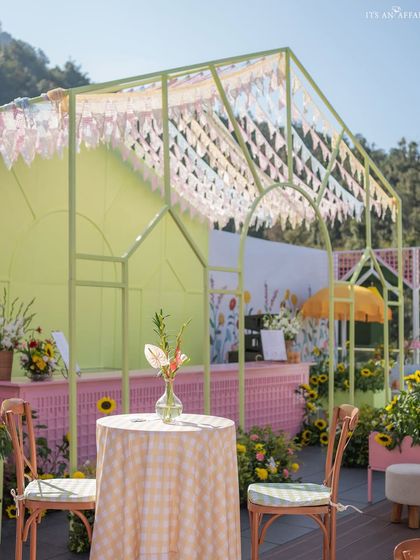 A pastel green and pink bar area, with a roof of delicate bunting, adds to the playful and colorful atmosphere.