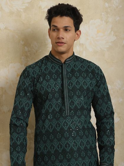 A close-up of a dark green kurta with geometric embroidery. The detailing on the collar and neckline makes it apt for any function.