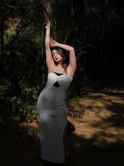 A graceful, reaching pose that creates a beautiful silhouette against the dark woods.